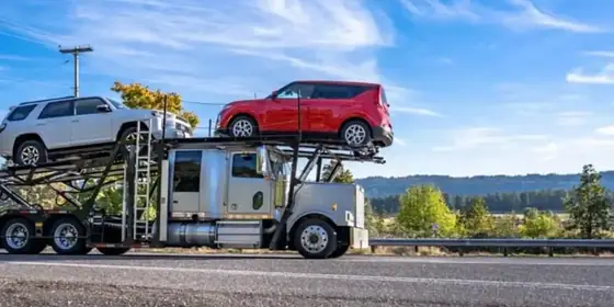 A loaded car carrier on a highway