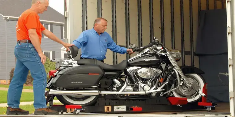 A touring motorcycle secured inside an enclosed trailer